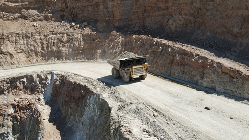 Large quarry dump truck full of stones. Transporting the ore into the crusher. Mining truck mining machinery, transport the material for production.