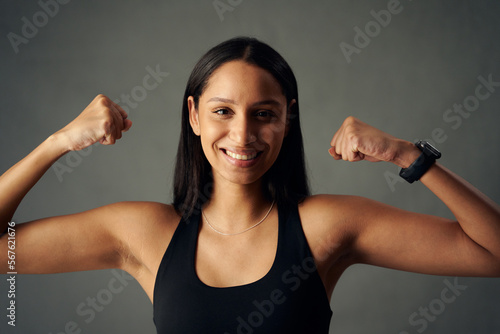 Fotografie Portrait of happy young biracial woman wearing sports bra and fitness tracker fl