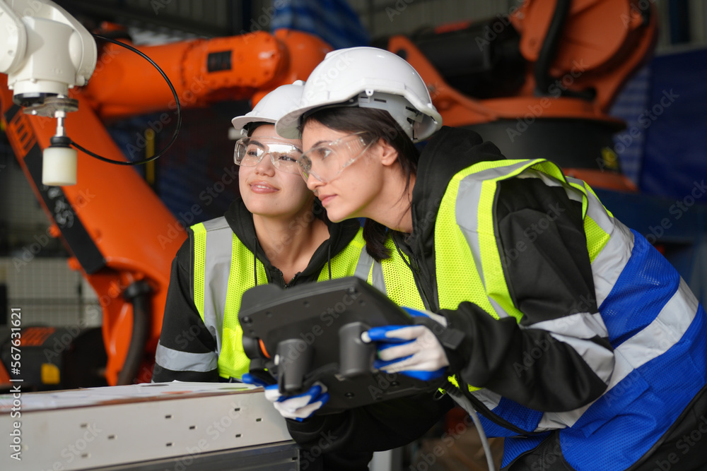 Fototapeta premium Engineer check and control welding robotics automatic arms machine in intelligent factory automotive industrial with monitoring system software. Digital manufacturing operation. Industry 4.0