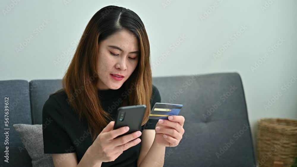 Asian woman while using credit card for shopping online on mobile phone applications. Asian woman while using credit card for shopping online on mobile phone applications.