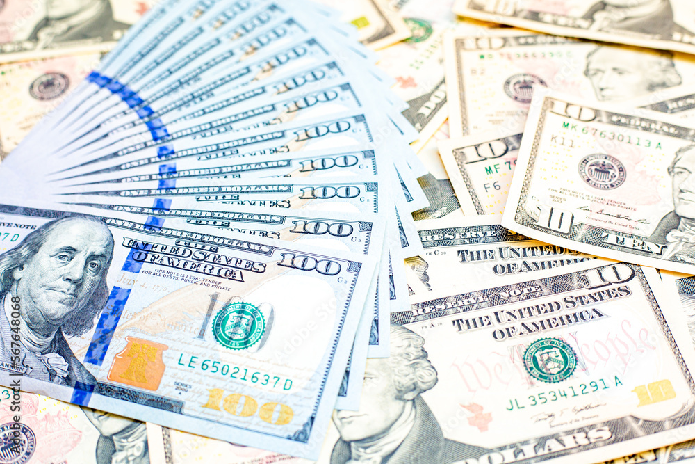 Fototapeta premium Group of money dollar banknotes arranged on dollar banknotes chaotic manner. Dollar banknotes isolated in a chaotic manner. Exchange money, Money, Cash and finances concept. Travel concept..