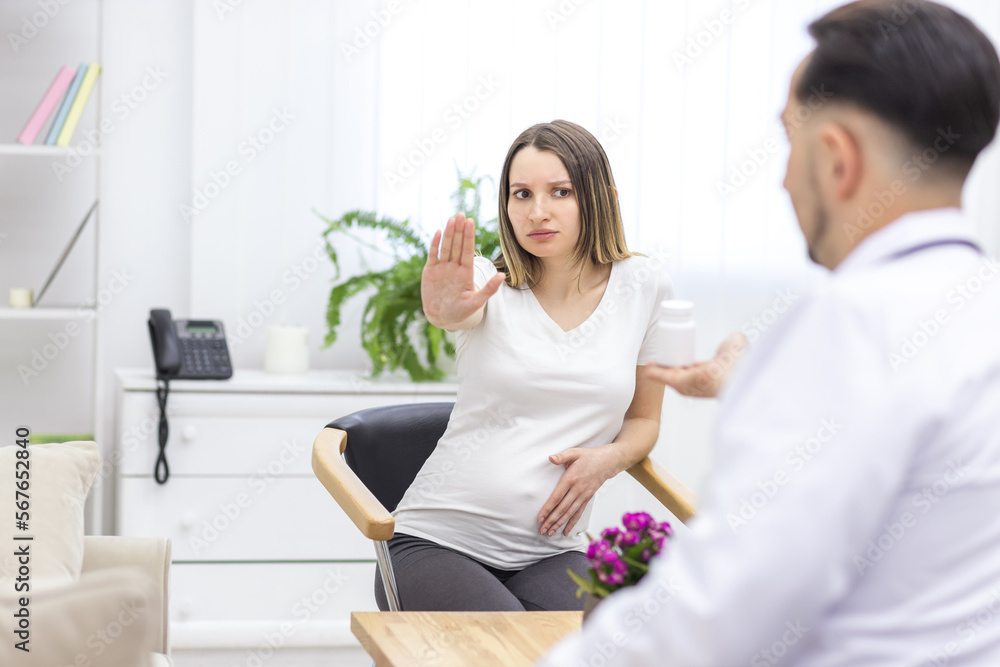 Photo of pregnant woman reaching out to doctor. Photo of pregnant woman reaching out to doctor.