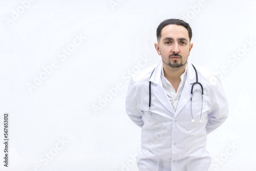 Photo of male mature doctor posing at camera with a stethoscope.