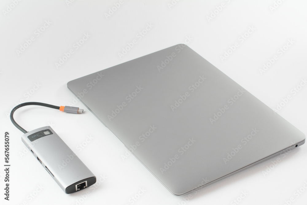 The USB adapter is connected to a laptop with various inputs for a flash drive, hdmi, ethernet, memory card, cables.