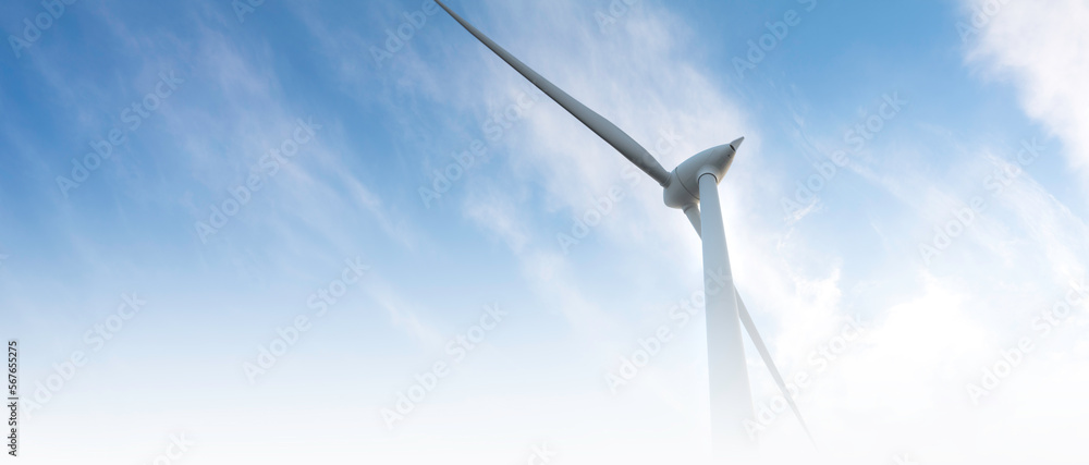 blurred banner windmill farm or wind park, with high wind turbines for generation electricity. Green energy generating concept. Sustainable development, renewable energy, winter, copy space
