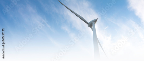 blurred banner windmill farm or wind park, with high wind turbines for generation electricity. Green energy generating concept. Sustainable development, renewable energy, winter, copy space