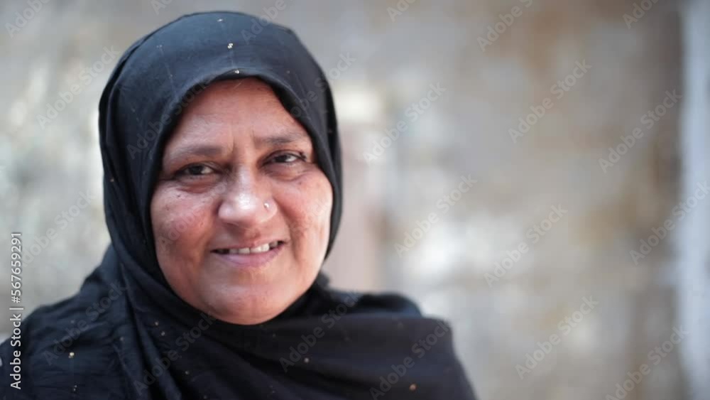 Shy Muslim woman smiling in front of a camera, woman smiling. Portrait of a Muslim woman in hijab looking straight in the camera and smiling. Shy Muslim woman smiling in front of a camera, woman smiling. Portrait of a Muslim woman in hijab looking straight in the camera and smiling.