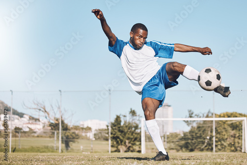 Sports, soccer and black man kick ball playing game, training and exercise on outdoor field. Fitness, workout and male football player in action, running and score goals, winning and competition
