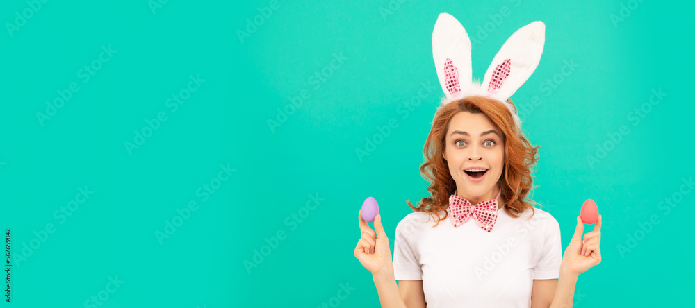 Easter bunny woman. surprised redhead woman in bunny rabbit ears with painted eggs, happy easter. Woman isolated face portrait, banner with mock up copyspace. Easter bunny woman. surprised redhead woman in bunny rabbit ears with painted eggs, happy easter. Woman isolated face portrait, banner with mock up copyspace.