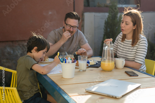 Family eats breakfast in the garden