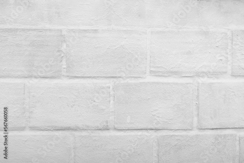 White brick wall in the foreground. Background, texture.