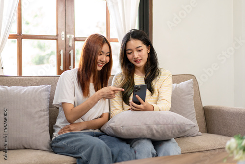 Young woman lesbian couple watching movie or entertainment on sm