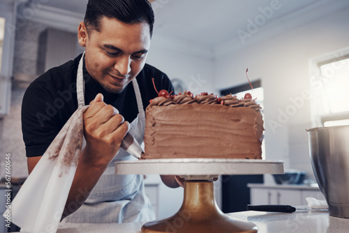 Fotografie Piping, bakery and chef baking a cake with chocolate and pastry in a kitchen and is happy decorating his recipe