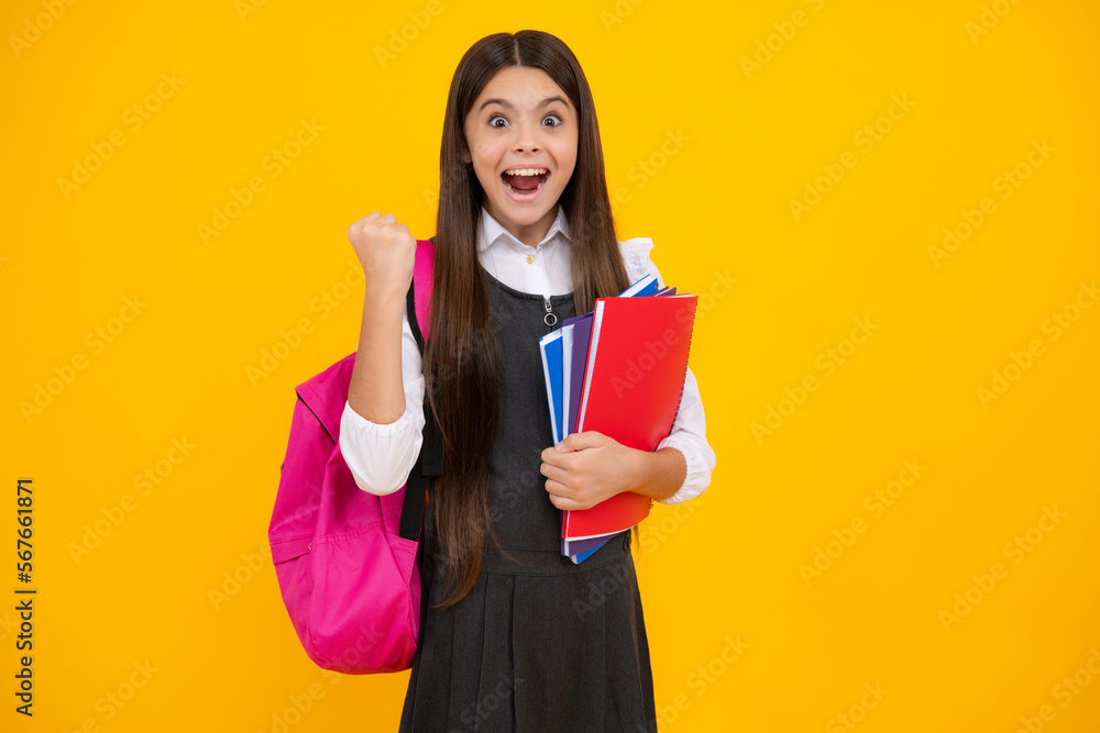Amazed teen girl. Back to school. School girl student with school bag backpack hold book on isolated studio background. Kids education concept. Excited expression, cheerful and glad. Amazed teen girl. Back to school. School girl student with school bag backpack hold book on isolated studio background. Kids education concept. Excited expression, cheerful and glad.