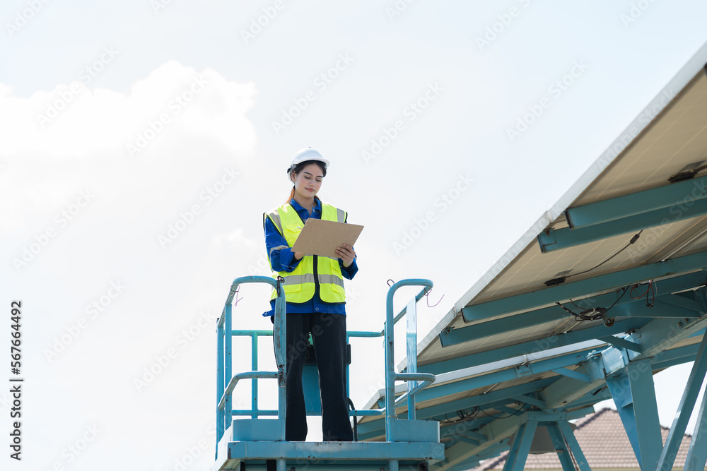 Female worker working on forklift truck working checking or maintenance solar panels power farm