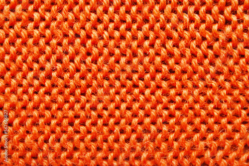 Orange color ornamental knitted surface texture as background 