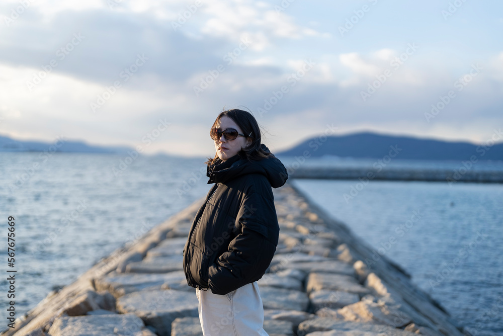 夕暮れの海でサングラスをしている女性 夕暮れの海でサングラスをしている女性