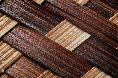 Super macro photo of texture brown and yellow color of woven bamboo pattern for wallpaper background.