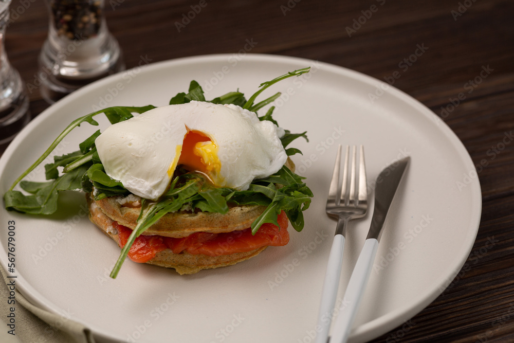 Squash waffles with poached egg, salmon and arugula