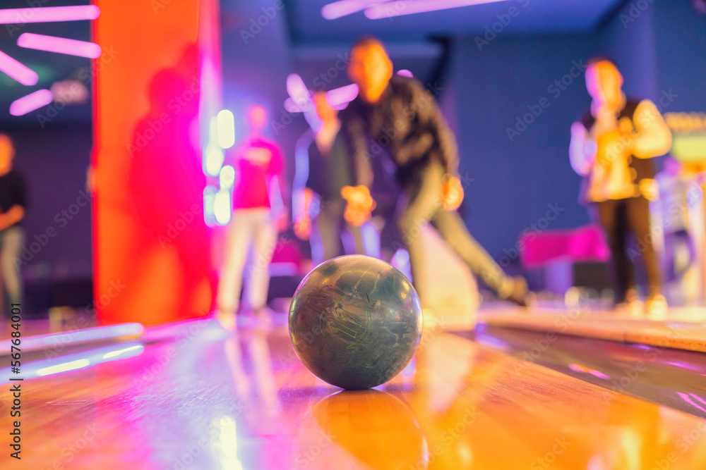 Bowling provides a fun and relaxed atmosphere for players looking to unwind and bond with loved ones, from amateurs to professionals, bowling attracts players of all skill levels - obrazy, fototapety, plakaty 