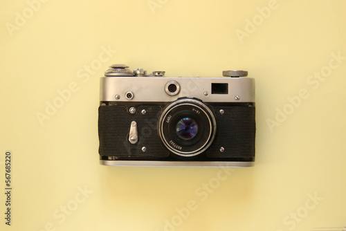 Beautiful vintage camera on a yellow background.