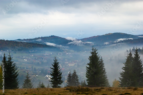 Fototapeta Naklejka Na Ścianę i Meble -  Autumn landscape with fog in the mountains. Fir forest on the hills. Carpathians, Ukraine, Europe. High quality photo