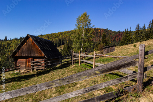 An old, abandoned farmhouse in a mountain meadow above the Carpathians. Beautiful walking landscape in Ukraine. autumn time © Oleh Marchak