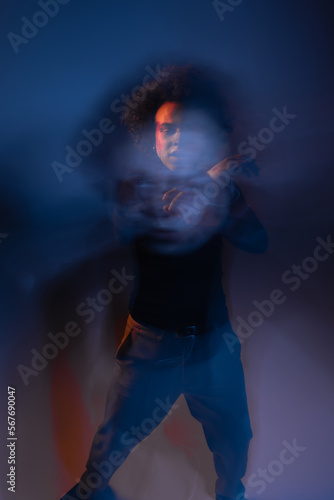 double exposure of abused african american man with injured face and bipolar disorder on dark with orange and blue light