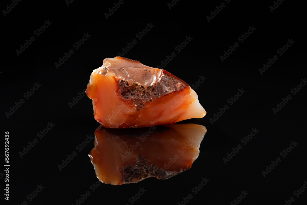 Carnelian Uncut Gem Stone on Black Background Carnelian Uncut Gem Stone on Black Background