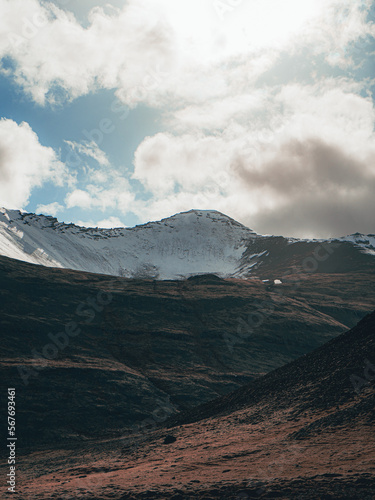 Breathtaking view of a snow-capped mountain on a sunny day with clouds in the sky in Iceland