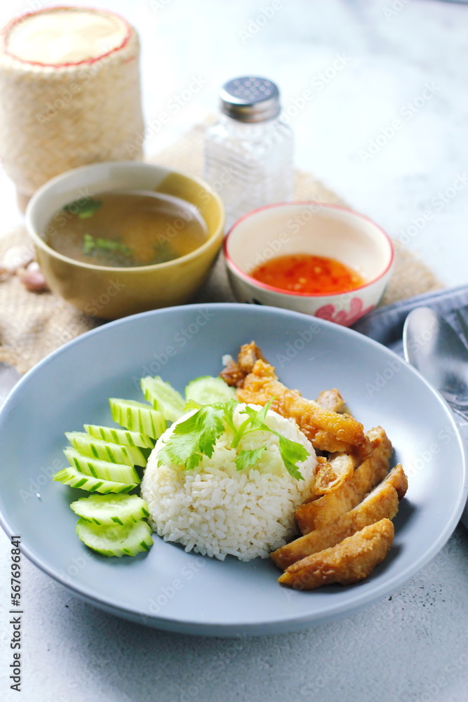 Thai style grilled chicken with rice and spicy soup on white background Thai style grilled chicken with rice and spicy soup on white background