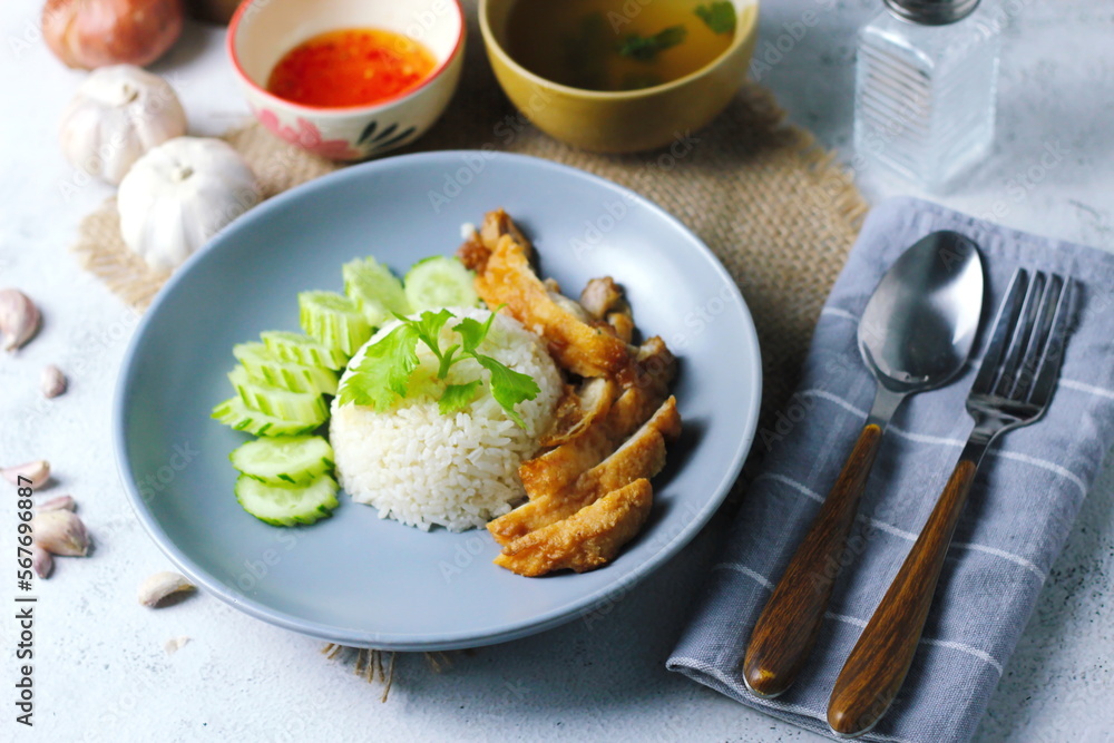 Thai style grilled chicken with rice and spicy soup on white background