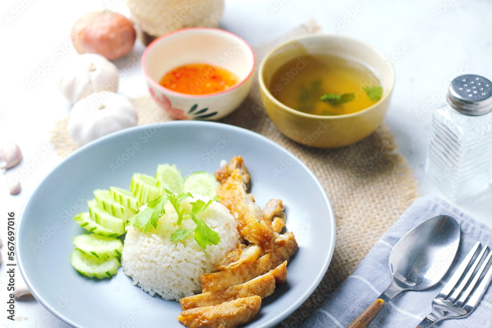 Thai style grilled chicken with rice and spicy soup on white background