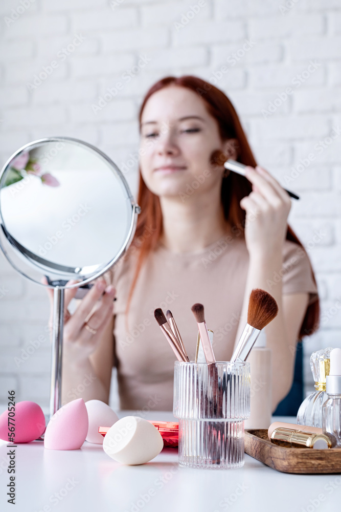young woman making up at home, using eyeshadows young woman making up at home, using eyeshadows