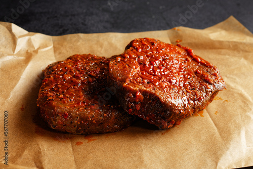 Two marinated beef steaks on a brown wrapping paper photo