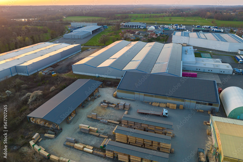 Aerial view of goods warehouses and logistics center in industrial city zone from above