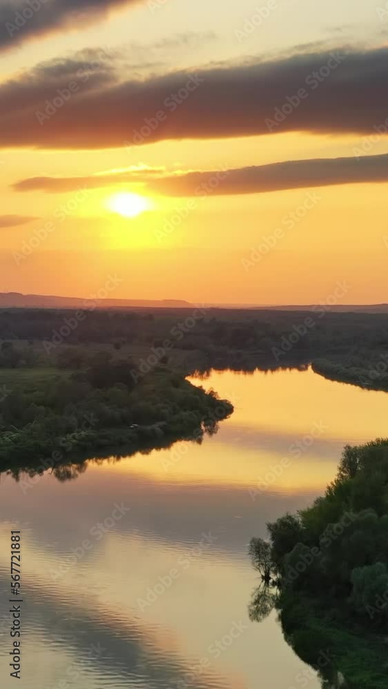 Aerial view landscape of sunrise or sunset with forest and river. Vertical video Aerial view landscape of sunrise or sunset with forest and river. Vertical video