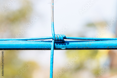 Steel wire fence from the grid with blue polymer coating. Knotted Fence. Tensile Mesh knotted wire mesh rust-resistant barbed, thick zinc plated. Can withstand tensile strength able to receive impact.
