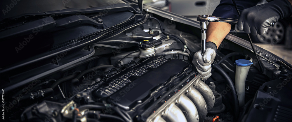 Car care maintenance and servicing, Close-up hand technician auto mechanic using the wrench to repairing change spare part car engine problem and car insurance service support. Car care maintenance and servicing, Close-up hand technician auto mechanic using the wrench to repairing change spare part car engine problem and car insurance service support.