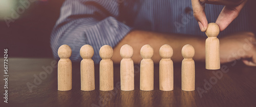 Canvas-taulu Hand choose wooden doll stand out first the group concept of relationship or HR human resources officer or business team and personnel management job performance