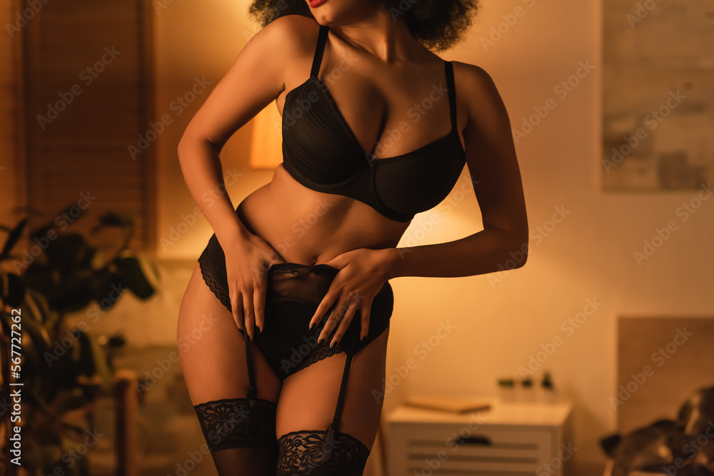 Φωτογραφία cropped view of passionate african american woman in black bra and stockings tou