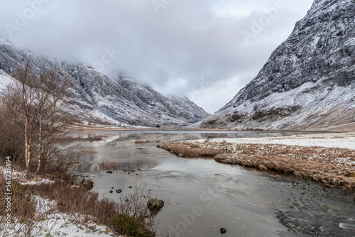 Loch Achtriochtan and the river Coe and winter snow in Glen Coe, Highlands, Scotland