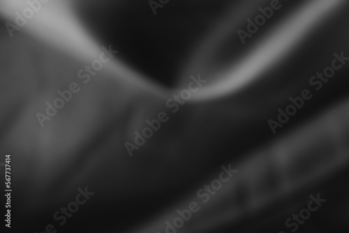 Dark black and gray blurred background has a little abstract light