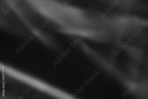 Dark black and gray blurred background has a little abstract light