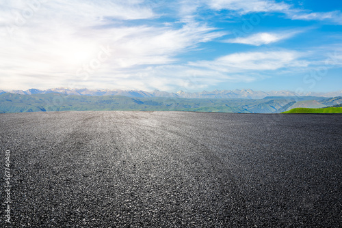 Asphalt road with green mountain nature background © ABCDstock
