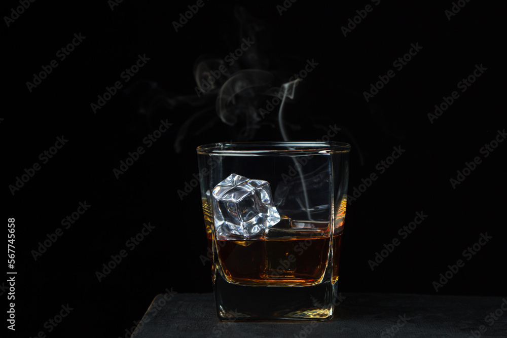 Glass of whiskey with ice on a black background. alcoholic drink Glass of whiskey with ice on a black background. alcoholic drink