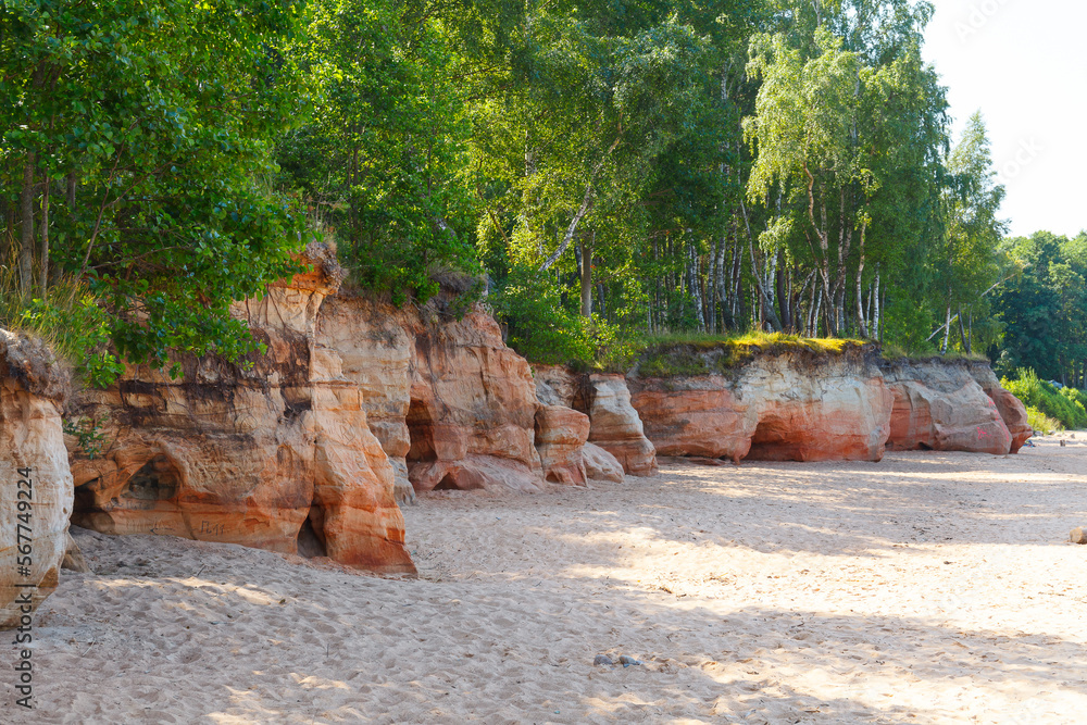 Obraz premium Veczemju klintis (Veczemju cliffs) on Baltic sea near Tuja, Latvia in summer season. Beautiful sea shore with limestone and sand caves