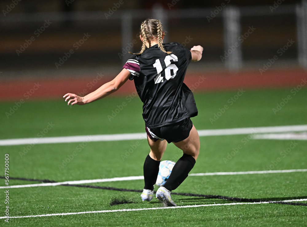 Obraz premium Young kids playing a competitive game of soccer and making great plays