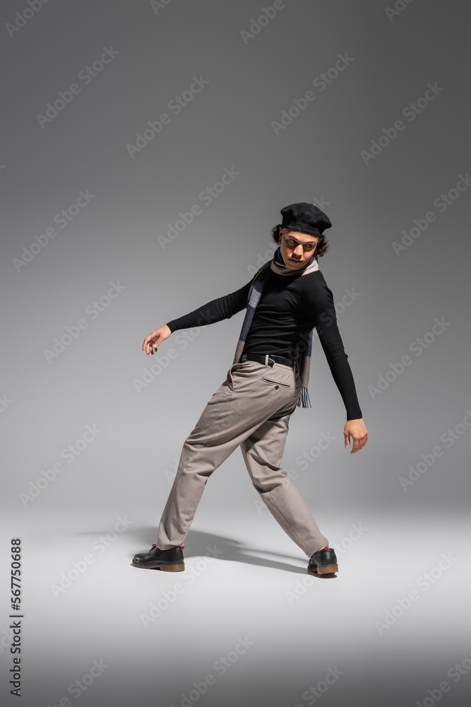 full length of african american man in black beret and fashionable casual attire posing on grey background full length of african american man in black beret and fashionable casual attire posing on grey background