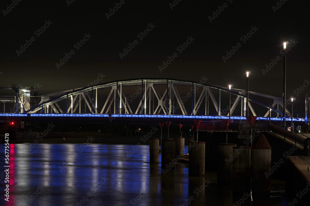 Naklejka premium Bridge over the river the Ijssel at night near the center of Zutphen in the Netherlands. The bridge is called Oude Ijsselbrug